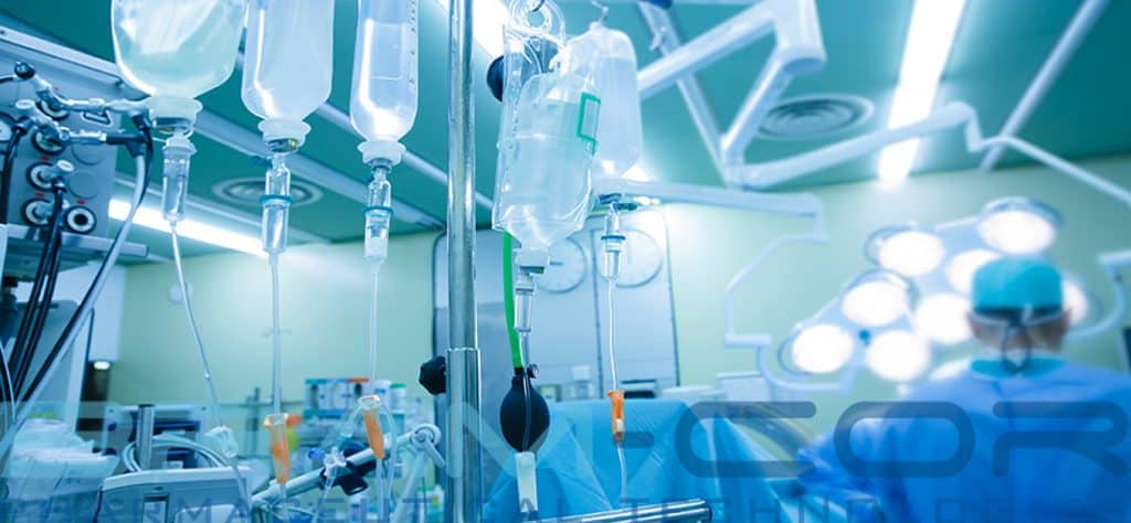 IV bags and bottles hanging on poles during real surgery